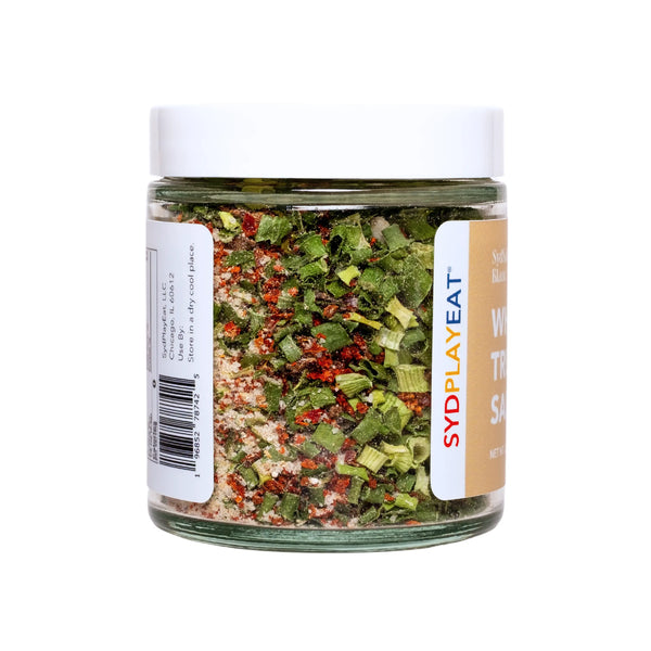 An image showing a container of truffle salt with visible truffle pieces.