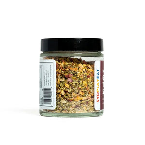 Jar of mixed truffle herbs or spices on a white background