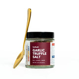 Jar of Sysball Garlic Truffle Salt with a gold spoon on a white background