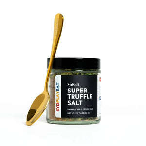 Jar of Super Truffle Salt with a gold spoon on a white background